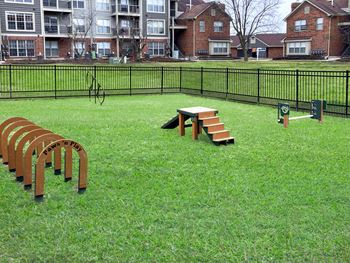 Green Trails Apartments fenced-in dog park with agility equipment